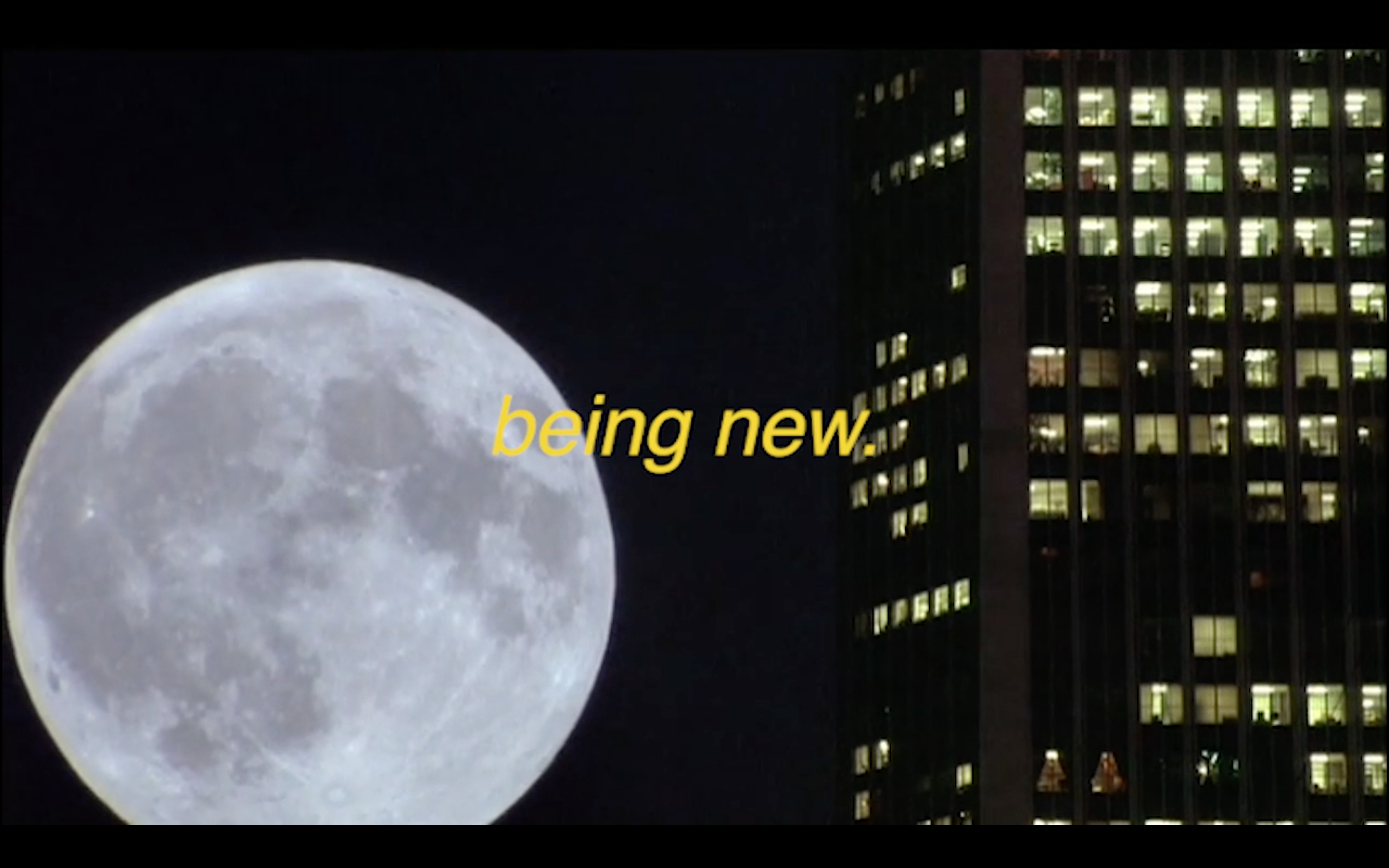 A still from The Transcribed Koyaanisqatsi of a shot of the full moon setting behind a skyscraper and the words being new in the middle of the image